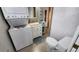Bathroom with stackable laundry and single sink vanity with ocean themed decor at 3333 26Th E Ave # 1145, Bradenton, FL 34208
