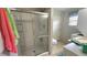 Bathroom featuring a shower with sliding glass doors, toilet, and a laundry area at 3333 26Th E Ave # 1145, Bradenton, FL 34208