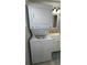 Bathroom with stackable laundry and single sink vanity featuring chrome fixtures at 3333 26Th E Ave # 1145, Bradenton, FL 34208
