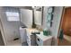 Bathroom with a stackable washer and dryer, a mirror, and beach-themed decor on the wall at 3333 26Th E Ave # 1145, Bradenton, FL 34208