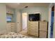 Bedroom featuring a TV on a dresser, with neutral carpet and light green walls at 3333 26Th E Ave # 1145, Bradenton, FL 34208