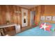 Bedroom featuring a twin bed, a desk, paneled walls, and beach-themed decor at 3333 26Th E Ave # 1145, Bradenton, FL 34208
