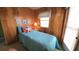 Small bedroom with paneled walls, a window, and a twin bed with a starfish pillow at 3333 26Th E Ave # 1145, Bradenton, FL 34208