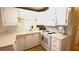 This kitchen features white cabinets, modern appliances, and tile backsplash at 3333 26Th E Ave # 1145, Bradenton, FL 34208