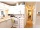 White kitchen featuring appliances, cabinets and access to the dining and bedroom areas at 3333 26Th E Ave # 1145, Bradenton, FL 34208