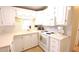 Well-lit kitchen with white cabinets, appliances, and a window with decorative backsplash at 3333 26Th E Ave # 1145, Bradenton, FL 34208