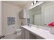 Clean bathroom featuring a vanity with a quartz countertop, a shower, and a toilet at 3419 74Th Avenue E Cir, Sarasota, FL 34243