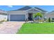 Charming single-story home features manicured lawn, brick driveway, and welcoming front entrance at 3419 74Th Avenue E Cir, Sarasota, FL 34243