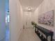 Inviting entryway with tile flooring, elegant console table, and decorative wall art at 3419 74Th Avenue E Cir, Sarasota, FL 34243
