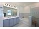 Spa-like main bathroom features double sinks, a soaking tub and separate glass enclosed shower at 3419 74Th Avenue E Cir, Sarasota, FL 34243