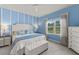 Bright bedroom with blue walls, a large window, and white furniture, offering a peaceful and serene retreat at 4609 Deep Creek Ter, Parrish, FL 34219