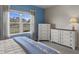 Cozy bedroom featuring matching dressers and a tranquil view from the large window at 4609 Deep Creek Ter, Parrish, FL 34219