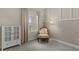 Cozy bedroom featuring a decorative chair, carpeted floors, and a well-lit window with neutral color at 4609 Deep Creek Ter, Parrish, FL 34219