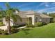 Charming single-Gathering home with manicured lawn, complemented by beautiful shrubbery and a palm tree at 4609 Deep Creek Ter, Parrish, FL 34219