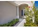 Inviting front porch with a white bench and lush greenery, offering a cozy spot to relax at 4609 Deep Creek Ter, Parrish, FL 34219