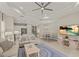 Open-concept living space with a modern kitchen, dining area, and cozy living room featuring neutral color tones at 4609 Deep Creek Ter, Parrish, FL 34219