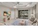 Spacious living room with large sliding doors leading to a screened lanai, featuring a ceiling fan and neutral tones at 4609 Deep Creek Ter, Parrish, FL 34219