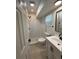 Updated bathroom with white vanity, and a walk-in shower, showcasing modern design at 4661 Linwood St, Sarasota, FL 34232