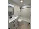 Renovated bathroom with modern fixtures, quartz vanity, and tiled shower/tub at 4661 Linwood St, Sarasota, FL 34232