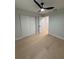 Bright bedroom with hardwood floors, modern ceiling fan, and closet storage at 4661 Linwood St, Sarasota, FL 34232
