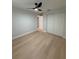Light-filled bedroom with modern ceiling fan, hardwood floors and closet at 4661 Linwood St, Sarasota, FL 34232