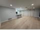 Bright open-concept living area with modern lighting, light wood floors, and breakfast bar seating at 4661 Linwood St, Sarasota, FL 34232