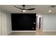 Open living area featuring a modern ceiling fan, hardwood floors, and a decorative accent wall at 4661 Linwood St, Sarasota, FL 34232