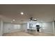 Bright living room featuring recessed lighting, hardwood floors, and kitchen with stainless appliances at 4661 Linwood St, Sarasota, FL 34232