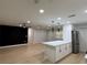 Bright, open-concept living room featuring a modern island, hardwood floors, and recessed lighting at 4661 Linwood St, Sarasota, FL 34232