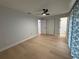 Bright main bedroom with hardwood floors, ceiling fan, and updated closet space at 4661 Linwood St, Sarasota, FL 34232
