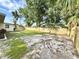 The house has a spacious backyard with new fence, grass, and mature trees at 6031 11Th E St, Bradenton, FL 34203