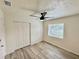 A well-lit bedroom featuring a spacious closet, new floors, a modern ceiling fan, and natural light at 6031 11Th E St, Bradenton, FL 34203