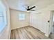 A well-lit bedroom featuring a spacious closet, new floors, a modern ceiling fan, and natural light at 6031 11Th E St, Bradenton, FL 34203