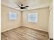 Bright bedroom featuring new floors, a modern ceiling fan, and two windows that allow natural light to enter at 6031 11Th E St, Bradenton, FL 34203
