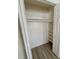Walk-in closet featuring built-in shelving and wood-look floors at 6031 11Th E St, Bradenton, FL 34203