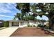 The home's exterior boasts an established shade tree, updated landscaping and a painted driveway at 6031 11Th E St, Bradenton, FL 34203