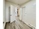 Hallway with modern wood-look floors leading to the kitchen and utility room at 6031 11Th E St, Bradenton, FL 34203