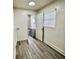 Hallway leading to bathroom and utility room with window and closet at 6031 11Th E St, Bradenton, FL 34203