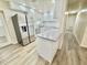 Renovated kitchen boasting stainless steel appliances, modern white cabinetry, and an island at 6031 11Th E St, Bradenton, FL 34203