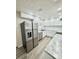 Modern kitchen showcasing stainless steel appliances, sleek white cabinets, and granite countertops at 6031 11Th E St, Bradenton, FL 34203