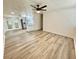 Spacious living room with hardwood floors, modern ceiling fan, and a clear view into the kitchen at 6031 11Th E St, Bradenton, FL 34203