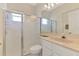Bathroom showcasing a walk-in shower with glass doors, a mirror, and vanity with marble countertop at 6644 Butlers Crest Dr, Bradenton, FL 34203