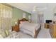 The main bedroom has a tray ceiling, fan, ensuite bath, and is decorated in soft, neutral tones at 6644 Butlers Crest Dr, Bradenton, FL 34203