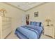 Bedroom with neutral walls, ceiling fan, dresser, and end table providing a comfortable space at 6644 Butlers Crest Dr, Bradenton, FL 34203