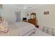 This well-lit bedroom has light carpet, a tray ceiling with fan, and wood furniture at 6644 Butlers Crest Dr, Bradenton, FL 34203