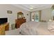 This spacious bedroom features a tray ceiling with fan and access to the backyard pool at 6644 Butlers Crest Dr, Bradenton, FL 34203