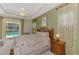 This bedroom boasts a tray ceiling, fan, and pool views from the sliding glass door at 6644 Butlers Crest Dr, Bradenton, FL 34203