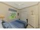 Comfortable bedroom with neutral walls, ceiling fan, closet and window, providing a relaxing retreat at 6644 Butlers Crest Dr, Bradenton, FL 34203