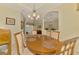 Elegant dining area with seating for six adjacent to a view of the living room at 6644 Butlers Crest Dr, Bradenton, FL 34203