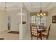Charming dining room with a chandelier, table with seating for six, and a columned entry at 6644 Butlers Crest Dr, Bradenton, FL 34203